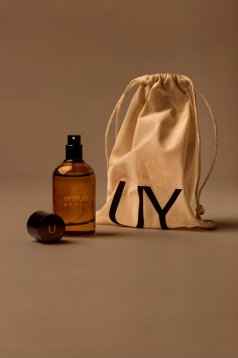 UY Studio U unisex eau de parfum, 50 ml amber glass bottle with engraved logo and black cap, oud, amber, vanilla, musk