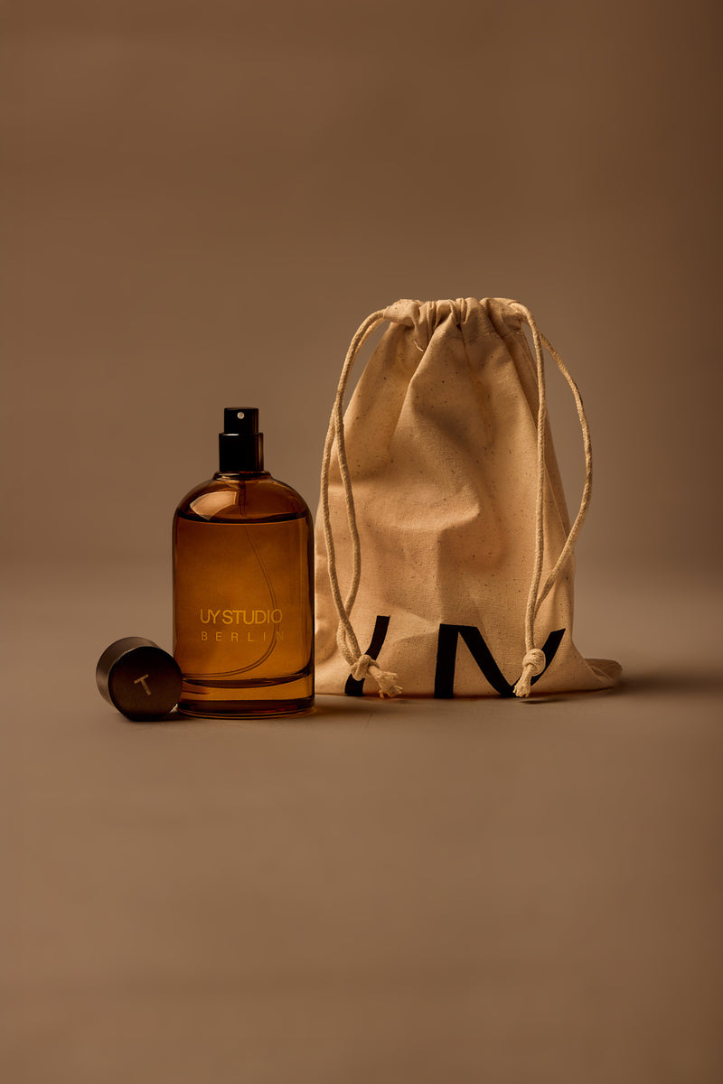 UY Studio T unisex room spray 100 ml amber glass bottle with engraved logo and black cap, Black Tea, Rose, Cedar, Musk scent, fragrance