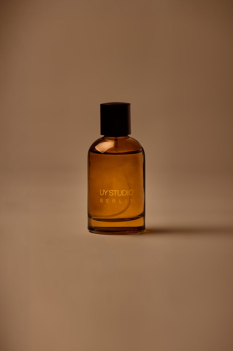 UY Studio S unisex room spray 100 ml amber glass bottle with engraved logo and black cap, bergamot, rose, cardamom, jasmine, amber