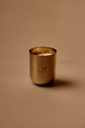 UY Studio X premium scented candle in a steel container, a niche home fragrance from Berlin with notes of patchouli, sandalwood, agarwood and tonka bean.