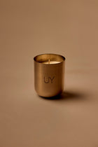 UY Studio X premium scented candle in a steel container, a niche home fragrance from Berlin with notes of patchouli, sandalwood, agarwood and tonka bean.