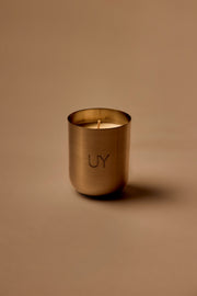 UY Studio X premium scented candle in a steel container, a niche home fragrance from Berlin with notes of patchouli, sandalwood, agarwood and tonka bean.